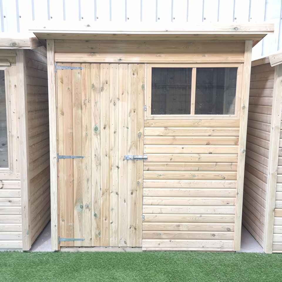 Custom-made Pent Shed by Websters Timber with sloping roof, shiplap cladding, and single door.